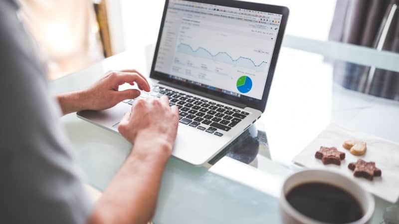 Hands on a laptop showing an analytics dashboard; cover for a creative fatigue monitoring guide